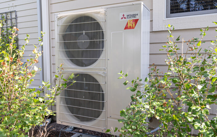 Image of a Mitsubishi HVAC unit outside of a home.